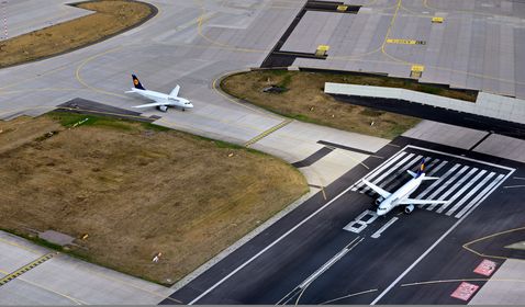 A picture of two planes on the runway